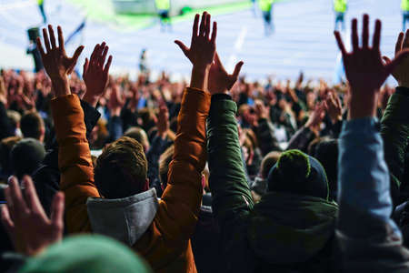 Football fans clapping on the podium of the stadiumの写真素材