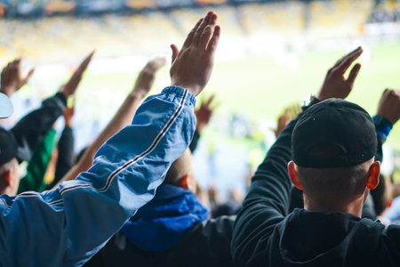 Football- soccer fans support their team and celebrate goal in full stadium with open air .