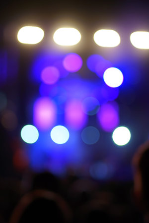 Defocused entertainment concert lighting on stage, blurred disco party.