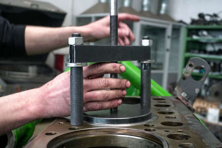 Male hand repairing car engineの写真素材