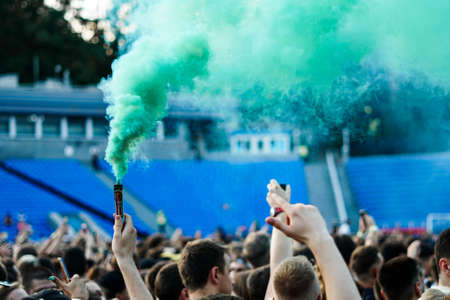 Crowd at a music concert, audience raising hands upの写真素材