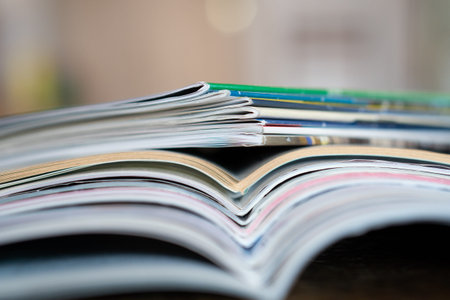 Closeup background of a pile of old magazines with bending pages