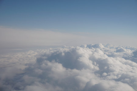 Pretty panorama of a cloudscape a landscape of clouds and sunbeams seen from above from an airplane...