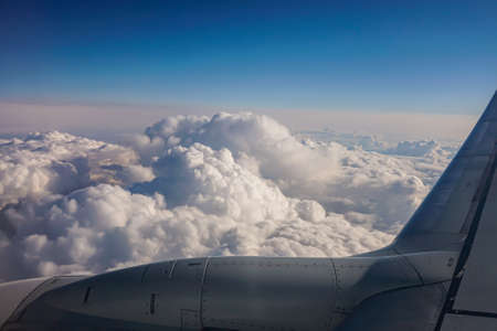 Image of wing and jet engine of airplane over blue sky.の写真素材