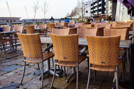 Modern and contemporary wooden wire net chairs. Outdoor minimalistic coffee shop design ideas.の写真素材