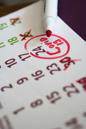guy paints a mark on the calendar, due to coronavirus Concept of the raging coronavirus pandemic in 2020の写真素材