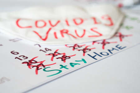 The inscription on the calendar.COVID-19. stay at homeの写真素材