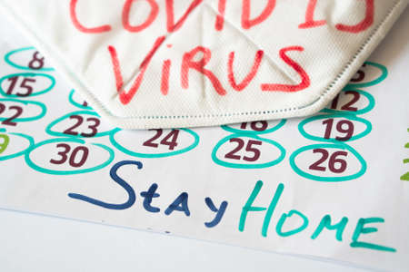 The inscription on the calendar.COVID-19. stay at homeの写真素材