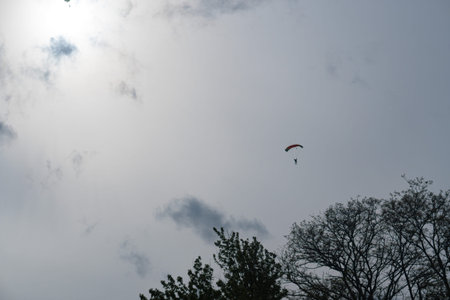 Silhouette of a parachutist in flight before sunset