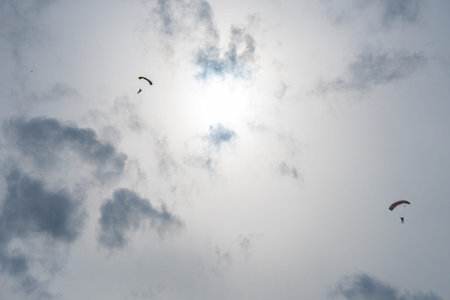 Silhouette of a parachutist in flight before sunset