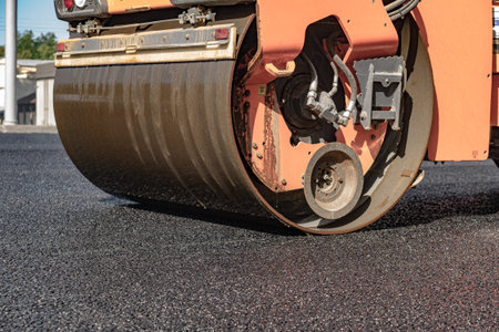 steamroller compact flatten out the asphalt tar
