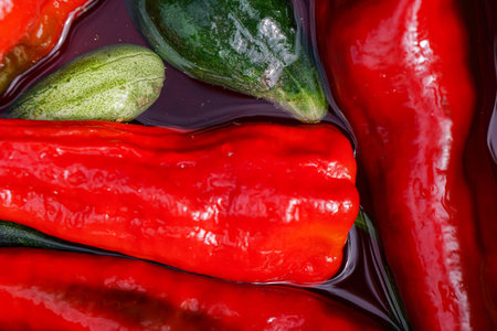 Vibrant colorful assortment of fresh organic bell peppers with water droplets ready to be sliced and cooked with in healthy salad mealの写真素材