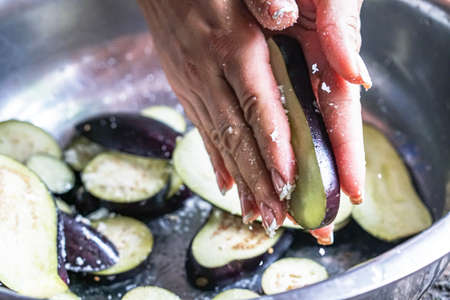 Girl preparing food on a table from eggplantの写真素材