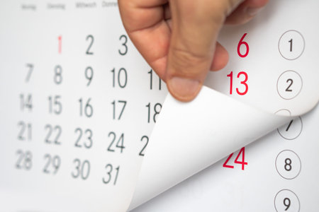 The man's hand turns the calendar.