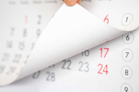 The man's hand turns the calendar.の写真素材