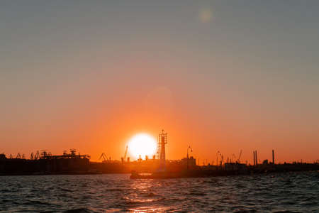 From the sea silhouette of tallinn with fire sea sunsetの写真素材
