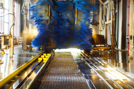 Car wash, black car in automatic car wash, rotating red and blue brush. Washing vehicle.の写真素材