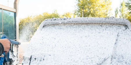 self-service car wash, self-service car wash, black car is washed with foam and waterblack car is washed with foam and waterの写真素材