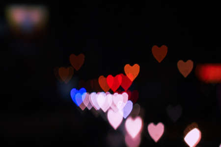 Heart bokeh background, Blurred background. Night city lights blur.Abstract image of blur motion of cars on the city road at nightの写真素材