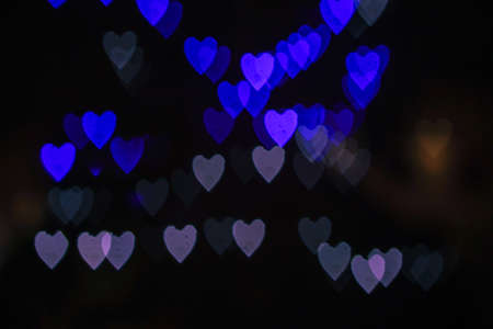 Heart bokeh background, Blurred background. Night city lights blur.Abstract image of blur motion of cars on the city road at nightの写真素材