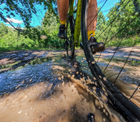 bicycle in motion view of the wheel, on the background of water and dirtの写真素材