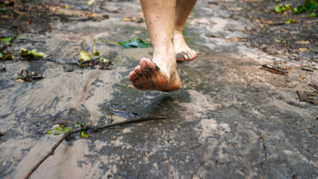 man walks in nature with bare feet, forest path and grassの写真素材
