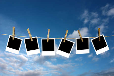 Four photos attached to a stringe with a defocused background.の写真素材