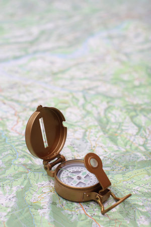 Brass compass on a topographic map