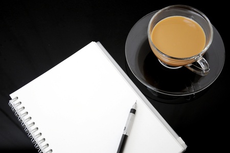 clear cup of coffee with notebookの写真素材