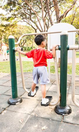 Boy excercises in the public parkの写真素材