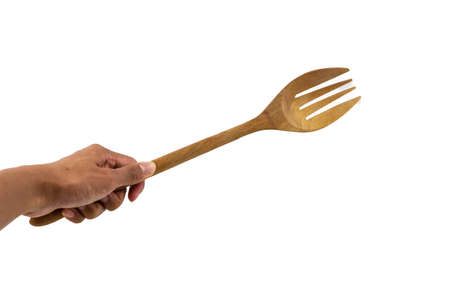 Wooden kitchen fork  on human hand isolated on white backgroundの写真素材