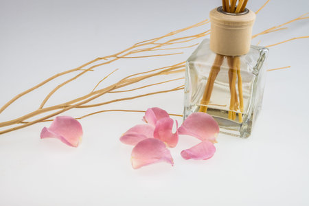 Aromatic sticks with light pink rose and dried wood stick