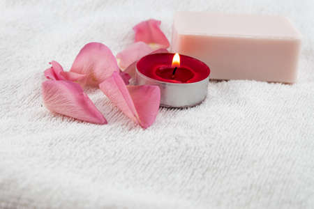 light pink rose,soap with tea light candle on white towelの写真素材