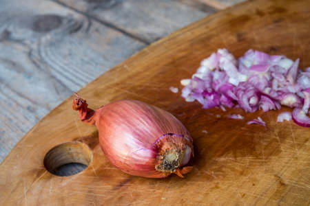 Red Onion Slices  on cutting board with old wooden backgroundの写真素材