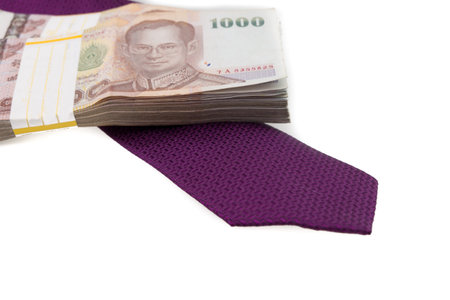 purple tie and Thailand money banknotes stacked  isolated