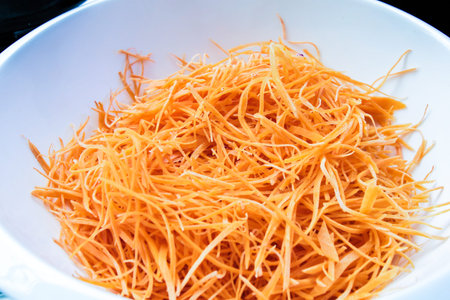 Cutting carrots into strips prepare for saladの写真素材