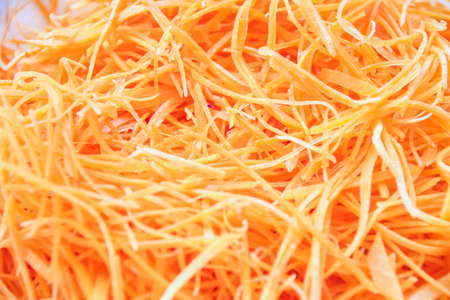 Cutting carrots into strips prepare for saladの写真素材