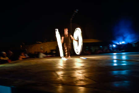 Dubai, United Arab Emirates - November 6, 2015: Fire dancer performing at Dubai Desert Safari.のeditorial素材