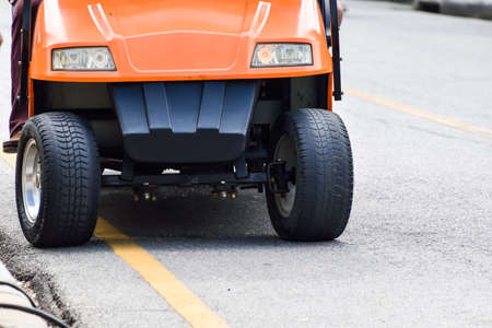 Red golf cart in the front.の写真素材