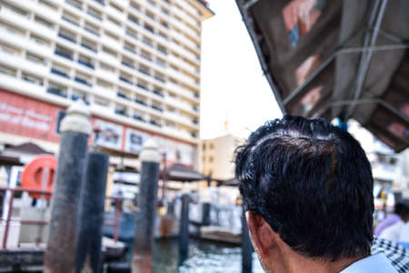 Dubai, United Arab Emirates -November 6, 2015: man on traditional abra ferries on November 6,2015 in Dubai, UAE. Shipbuilding technology is unchanged from the 18th century.のeditorial素材
