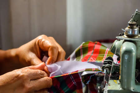 woman hand using sewing machine.の写真素材