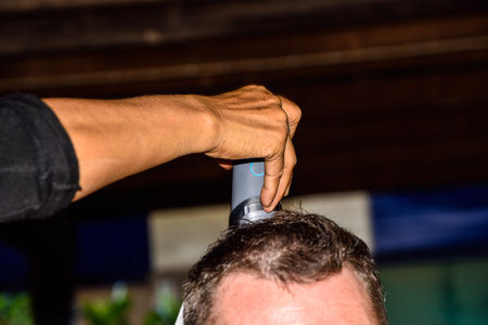 man getting haircut by hairdresser.