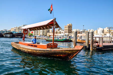 Dubai, United Arab Emirates -November 6, 2015:People on traditional abra ferries on November 6,2015 in Dubai, UAE. Shipbuilding technology is unchanged from the 18th century.のeditorial素材