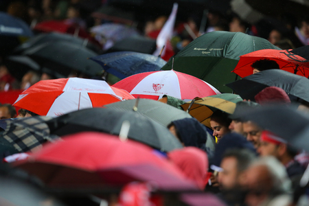SEVILLA, SPAIN - MAY 5: Sevilla FC fans hiding under umbrellas during the UEFA Europa League second leg semi-finals match between FC Shakhtar Donetsk vs Sevilla FC, 5 May 2016, Ramon Sanchez Pizjuan, Spainのeditorial素材