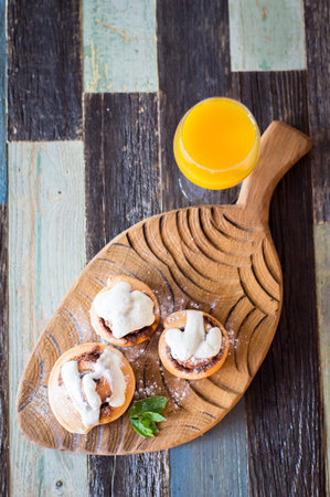 Homemade buns with cinnamon and a glass of juice