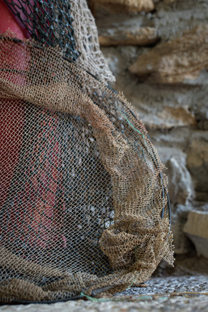 Old fishing net near the wall of an old house