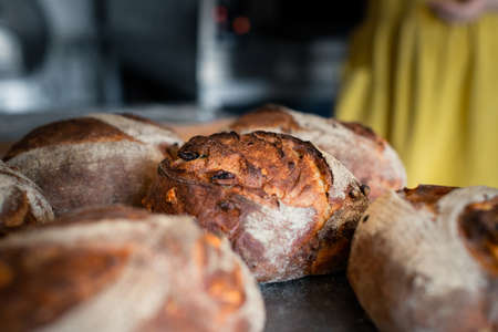 Lots of wheat bread on a table in a bakeryの写真素材