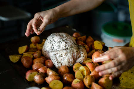 Cooking chicken baked with potatoesの写真素材