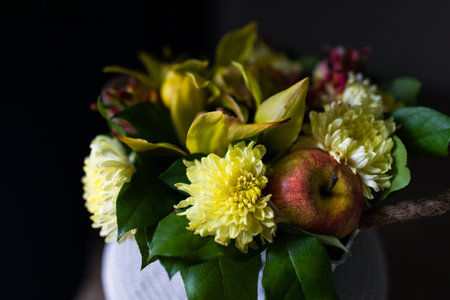 Bouquet of yellow chrysanthemums with apple, fresh flowers, artificial apple.の写真素材