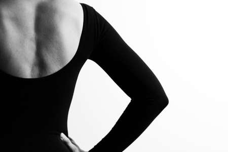 Woman from the back, shoulder, black and white photo, ballerinas clothes. Contrasting background, copy space.の写真素材